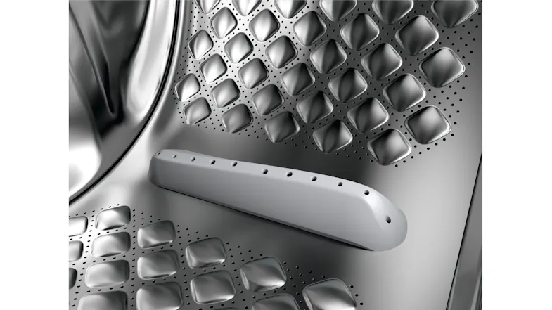 Close-up view of the washing machine steel drum with textured pattern Close-up view of the washing machine steel drum with textured pattern