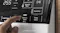 Close-up view of a hand pressing Energy Save buttons Close-up view of a hand pressing Energy Save buttons