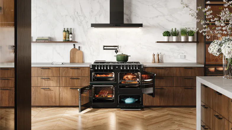 Belling cooker with all doors open, showing cooked roasts and meals inside the black oven cavities Belling cooker with all doors open, showing cooked roasts and meals inside the black oven cavities
