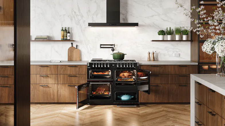 Belling cooker with all doors open, showing cooked roasts and meals inside the black oven cavities Belling cooker with all doors open, showing cooked roasts and meals inside the black oven cavities