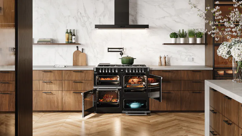 Belling cooker with all doors open, showing cooked roasts and meals inside the black oven cavities Belling cooker with all doors open, showing cooked roasts and meals inside the black oven cavities