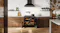 A contemporary kitchen with a range oven and marble walls A contemporary kitchen with a range oven and marble walls