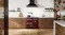 Wide kitchen scene featuring the freestanding oven positioned beneath a black rangehood Wide kitchen scene featuring the freestanding oven positioned beneath a black rangehood