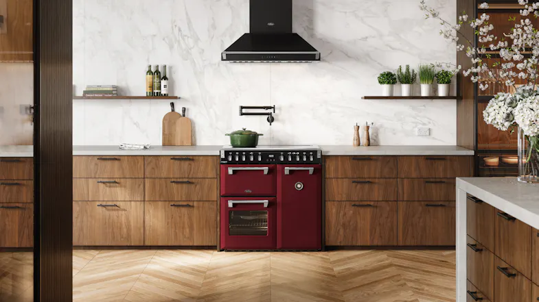 Wide kitchen scene featuring the freestanding oven positioned beneath a black rangehood Wide kitchen scene featuring the freestanding oven positioned beneath a black rangehood