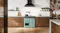 Wide kitchen scene featuring the freestanding oven positioned beneath a black rangehood Wide kitchen scene featuring the freestanding oven positioned beneath a black rangehood