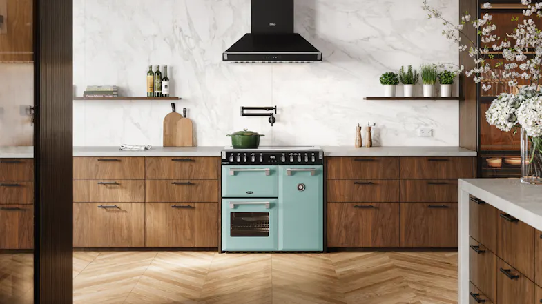 Wide kitchen scene featuring the freestanding oven positioned beneath a black rangehood Wide kitchen scene featuring the freestanding oven positioned beneath a black rangehood