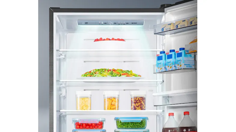 Interior view of the refrigerator compartment, featuring adjustable shelves, door storage, and crisper drawers Interior view of the refrigerator compartment, featuring adjustable shelves, door storage, and crisper drawers