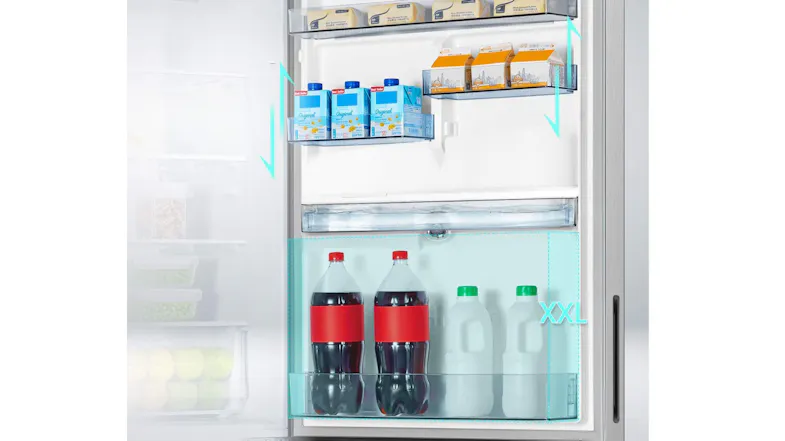 Close-up of the refrigerator interior stocked with beverages and groceries, highlighting spacious shelving Close-up of the refrigerator interior stocked with beverages and groceries, highlighting spacious shelving