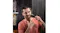A person using a Wahl Groomsman trimmer to groom a beard along the jawline in a bathroom A person using a Wahl Groomsman trimmer to groom a beard along the jawline in a bathroom