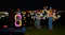 A crowd partying in the background while the speaker is playing music A crowd partying in the background while the speaker is playing music
