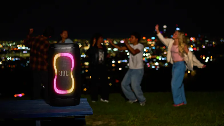 A crowd partying in the background while the speaker is playing music A crowd partying in the background while the speaker is playing music