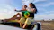 Lifestyle image of a person seated outdoors with the JBL PartyBox On-The-Go 2 Plus speaker Lifestyle image of a person seated outdoors with the JBL PartyBox On-The-Go 2 Plus speaker