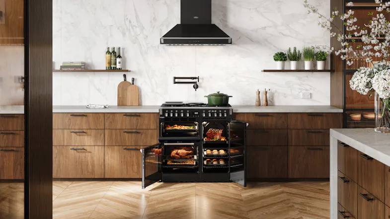 A contemporary kitchen with a range oven and marble walls A contemporary kitchen with a range oven and marble walls