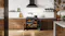 A contemporary kitchen with a range oven and marble walls A contemporary kitchen with a range oven and marble walls