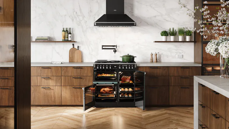 A contemporary kitchen with a range oven and marble walls A contemporary kitchen with a range oven and marble walls