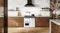A luxury kitchen with a freestanding oven filled with cooked dishes A luxury kitchen with a freestanding oven filled with cooked dishes