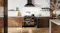 A contemporary kitchen with a range oven and marble walls A contemporary kitchen with a range oven and marble walls