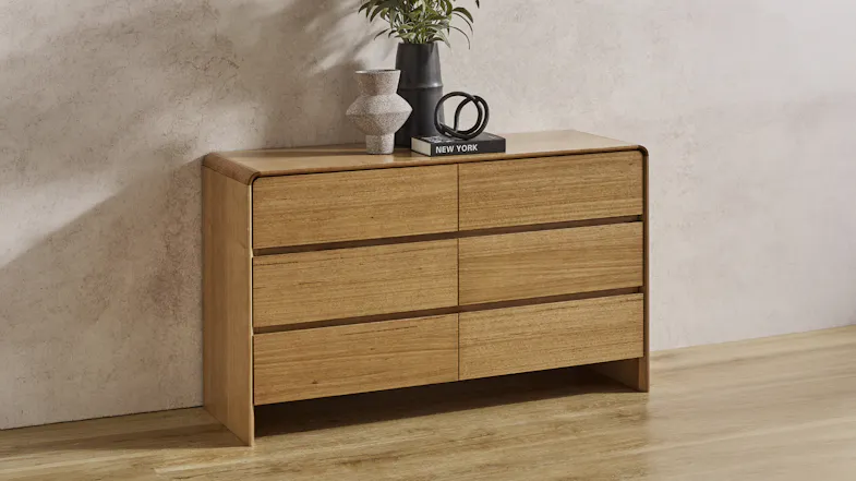 Angled view of the Cassie dresser in a room setting, showcasing its smooth and rounded-edge design Angled view of the Cassie dresser in a room setting, showcasing its smooth and rounded-edge design