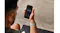 A view of a person wearing the smart band on their wrist while holding a smartphone A view of a person wearing the smart band on their wrist while holding a smartphone