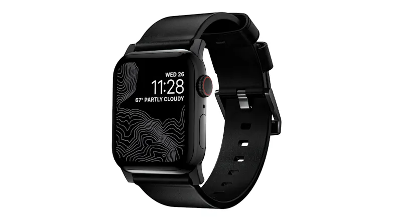 An angled view of a black Apple Watch featuring a matching black leather band, matte black hardware, and custom lugsA top-down overhead view of a black Apple Watch with a long black leather strap laid flat. An angled view of a black Apple Watch featuring a matching black leather band, matte black hardware, and custom lugsA top-down overhead view of a black Apple Watch with a long black leather strap laid flat.