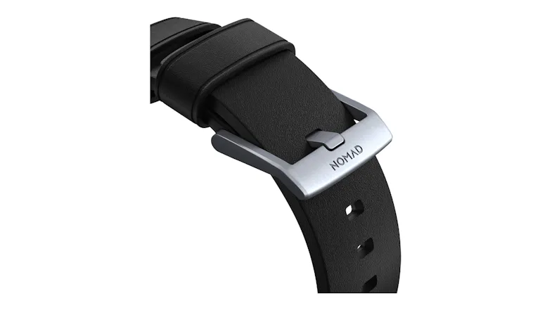 A detailed close-up of a black watch strap with a brushed silver metal buckle A detailed close-up of a black watch strap with a brushed silver metal buckle