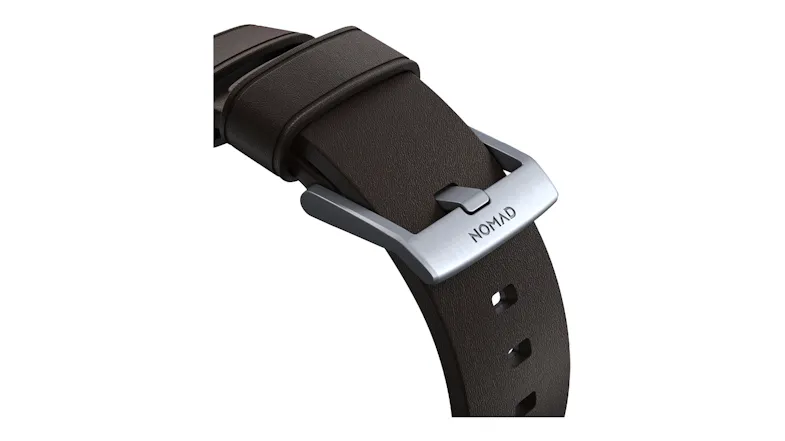 A detailed close-up of a brown watch strap with a brushed silver metal buckle A detailed close-up of a brown watch strap with a brushed silver metal buckle