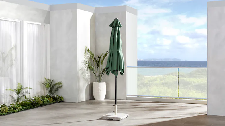 Pakiri round outdoor umbrella shown fully closed, with a dark green polyester canopy Pakiri round outdoor umbrella shown fully closed, with a dark green polyester canopy