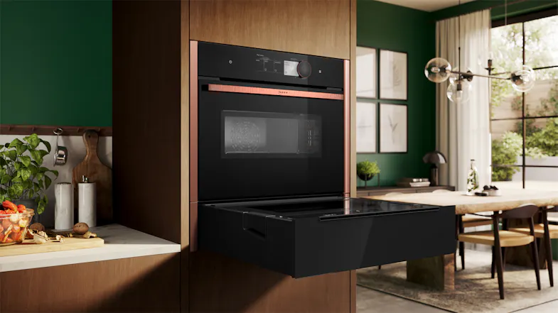 Open black Neff N 90 Series 14cm Built-In Steam Drawer installed below a matching oven in a modern kitchen Open black Neff N 90 Series 14cm Built-In Steam Drawer installed below a matching oven in a modern kitchen