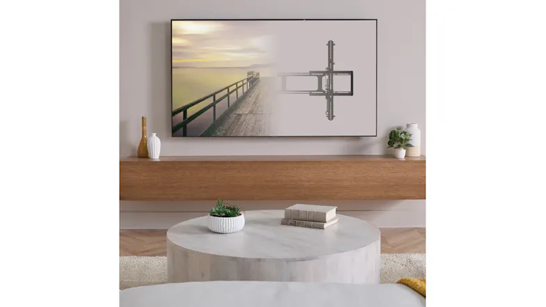 Wall-mounted TV on a low-profile bracket above a floating shelf in a modern living room Wall-mounted TV on a low-profile bracket above a floating shelf in a modern living room