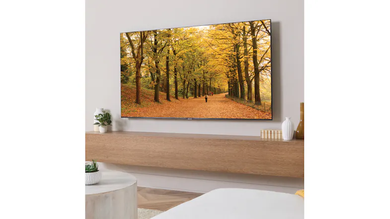 Large flat-screen TV mounted above a floating shelf in a modern living room Large flat-screen TV mounted above a floating shelf in a modern living room