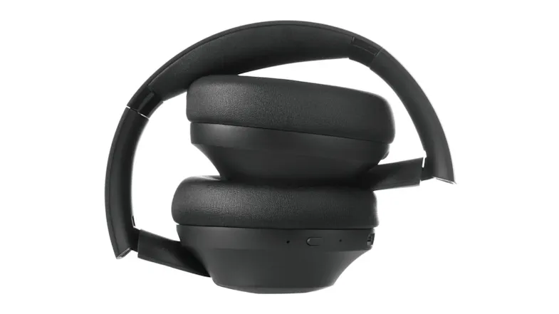 Folded black headphones displayed in a compact storage position, highlighting the foldable ear cup Folded black headphones displayed in a compact storage position, highlighting the foldable ear cup