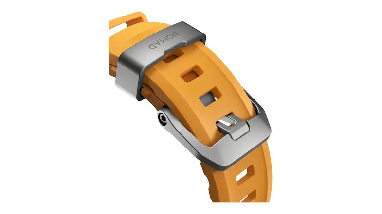 A close-up view of a rubber watch strap featuring a titanium buckle mechanism and strap loop with Nomad engraving A close-up view of a rubber watch strap featuring a titanium buckle mechanism and strap loop with Nomad engraving