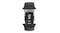 Close-up view of a rubber watch strap with titanium buckle hardware and watch attachment lugs on top and bottom Close-up view of a rubber watch strap with titanium buckle hardware and watch attachment lugs on top and bottom
