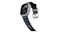 Angled view of Apple Watch Ultra showing topographic map display, rubber strap curving down, and titanium buckle Angled view of Apple Watch Ultra showing topographic map display, rubber strap curving down, and titanium buckle