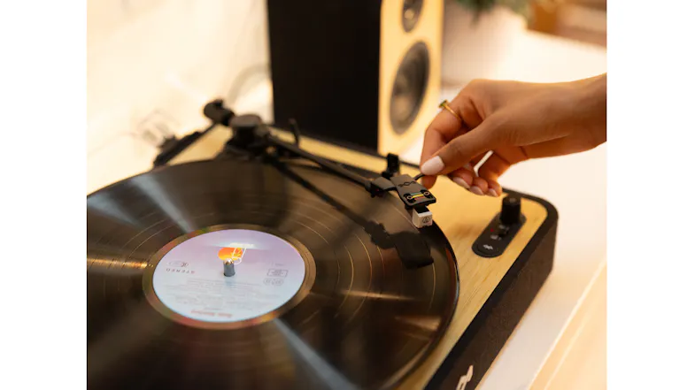Lifestyle shot featuring hands interacting with the turntable Lifestyle shot featuring hands interacting with the turntable