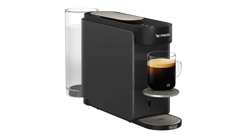 Side view of the espresso machine with glass mug featuring dark brew and crema layer Side view of the espresso machine with glass mug featuring dark brew and crema layer