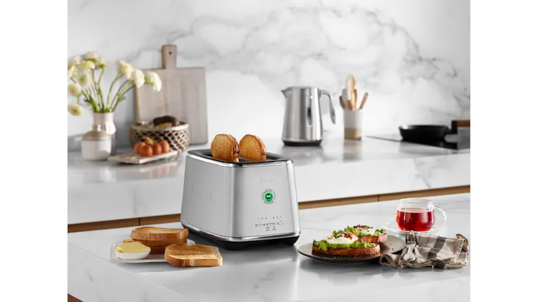 Lifestyle view showing toaster beside breakfast setup Lifestyle view showing toaster beside breakfast setup