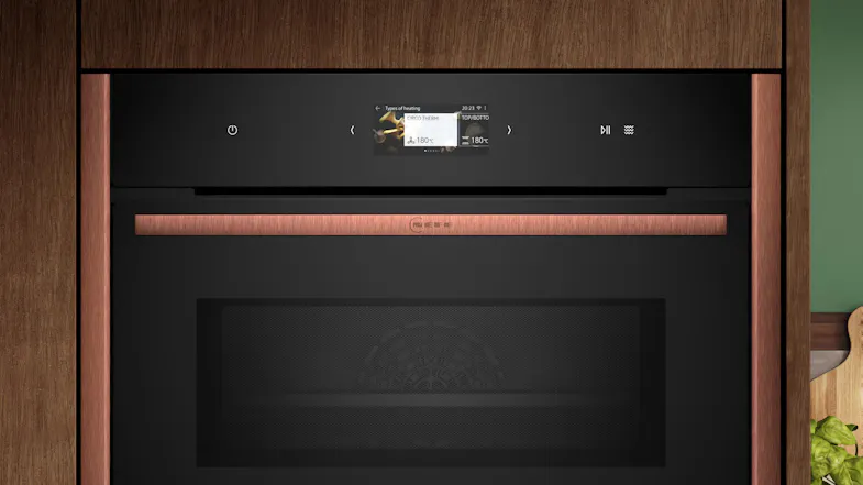 Neff N 90 compact oven with microwave function installed within modern wooden cabinetry Neff N 90 compact oven with microwave function installed within modern wooden cabinetry