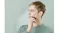 A person using a compact Panasonic travel shaver on the cheek during a shaving routine A person using a compact Panasonic travel shaver on the cheek during a shaving routine