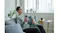Person relaxing on a sofa while holding a Panasonic travel shaver in its closed protective case Person relaxing on a sofa while holding a Panasonic travel shaver in its closed protective case