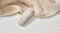 Close-up of the Majestic Motion adjustable base remote control resting on the mattress, featuring buttons Close-up of the Majestic Motion adjustable base remote control resting on the mattress, featuring buttons