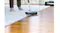 Person vacuuming wooden floor with smooth motion and reflection Person vacuuming wooden floor with smooth motion and reflection
