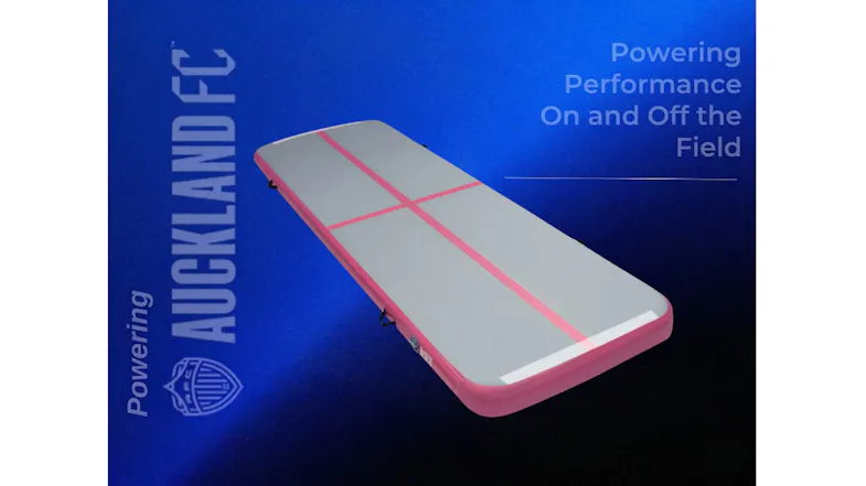 Inflatable air tumbling mat with a grey surface and pink trim, shown in a promotional graphic Inflatable air tumbling mat with a grey surface and pink trim, shown in a promotional graphic