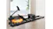 A water resistance rowing machine with an orange tank placed on a light wood floor in a brightly lit modern room A water resistance rowing machine with an orange tank placed on a light wood floor in a brightly lit modern room