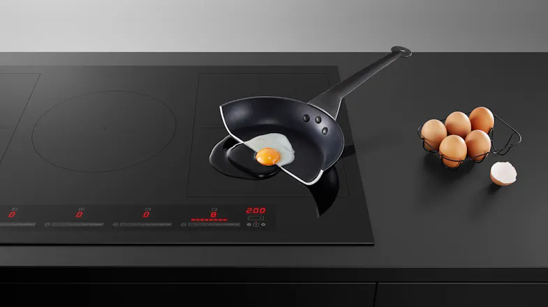 Fisher & Paykel induction cooktop shown in use with a frying pan and ingredients nearby Fisher & Paykel induction cooktop shown in use with a frying pan and ingredients nearby