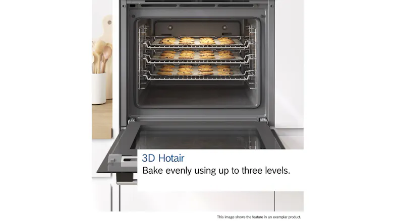 Front view of an open oven showcasing multiple trays of baked goods inside Front view of an open oven showcasing multiple trays of baked goods inside