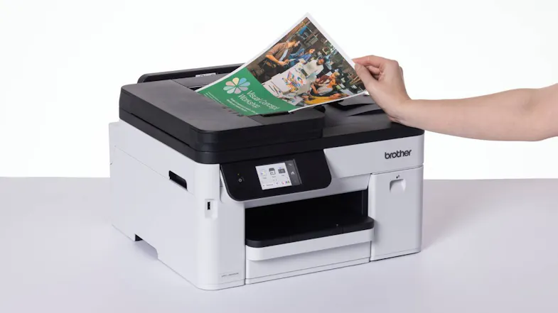 All-in-one printer scanning a colour document through the automatic document feeder All-in-one printer scanning a colour document through the automatic document feeder