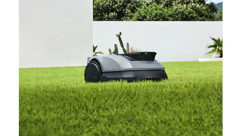 A view of the robotic lawn mower moving across the yard A view of the robotic lawn mower moving across the yard