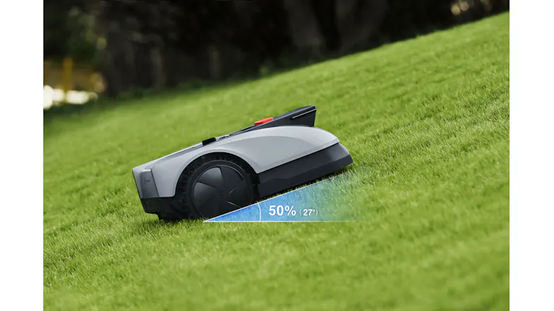 A view of the robotic lawn mower moving upwards on a steep terrain A view of the robotic lawn mower moving upwards on a steep terrain