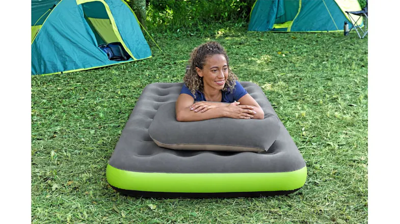 A portable air mattress and pillow providing comfortable sleeping support at a forest campsite A portable air mattress and pillow providing comfortable sleeping support at a forest campsite